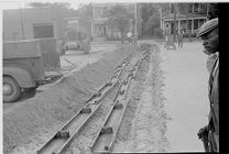 Construction of parking lots & men laying track 